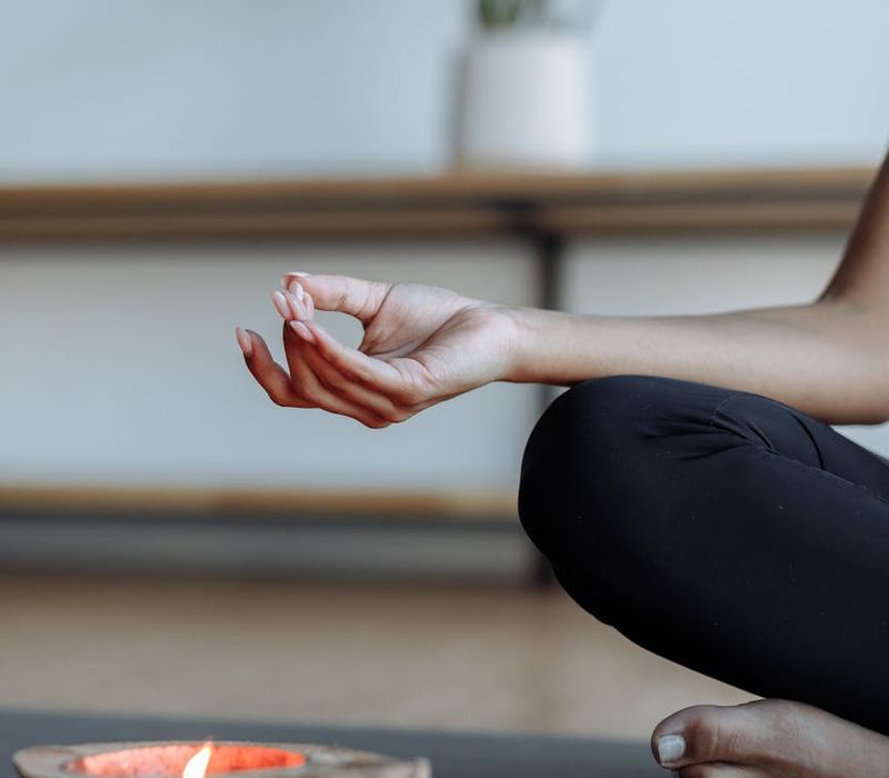 Close-up of hands in a mudra gesture, symbolizing focus and inner peace.